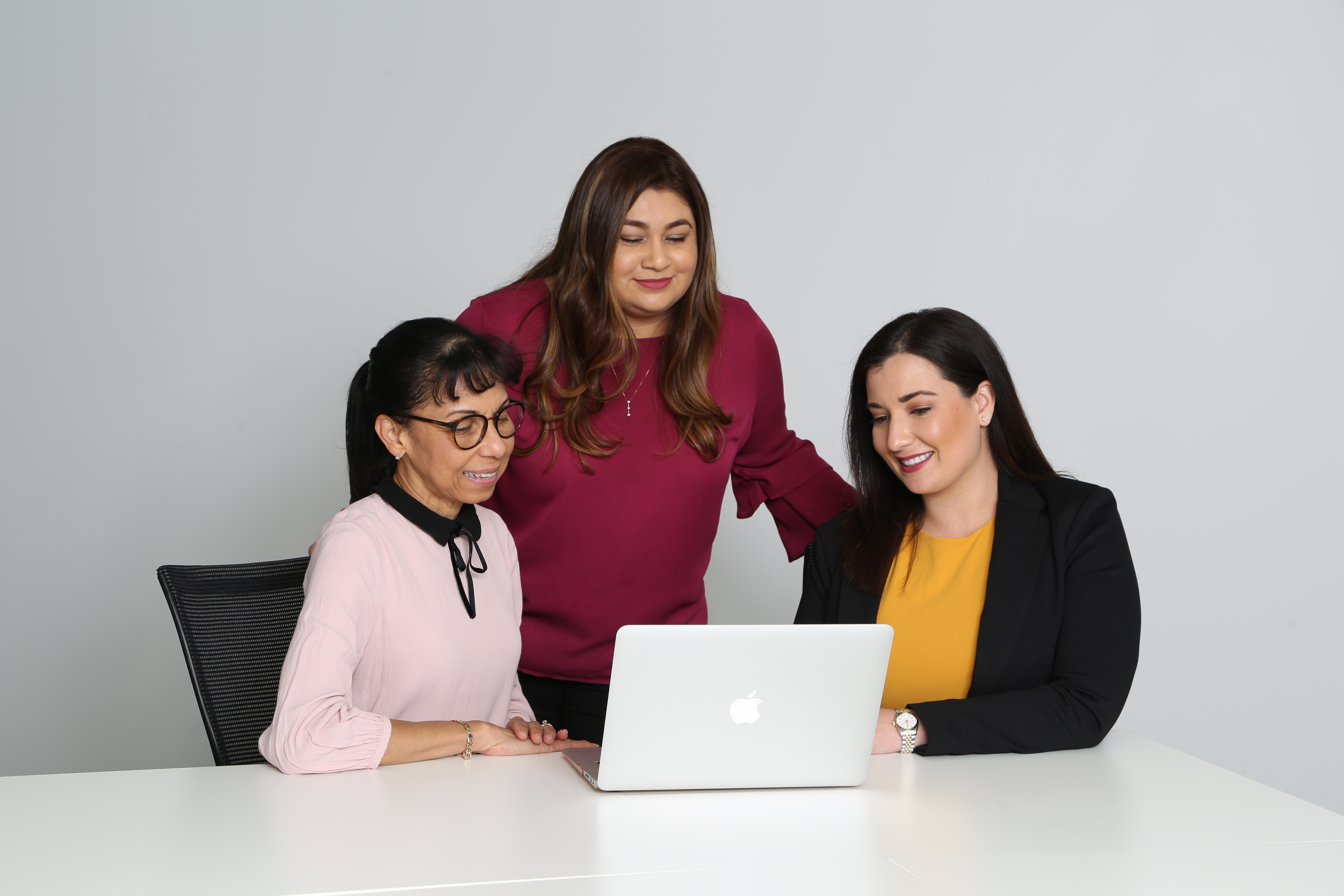 three girls looking on laptop